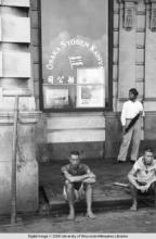 Hong Kong, men sitting on the sidewalk