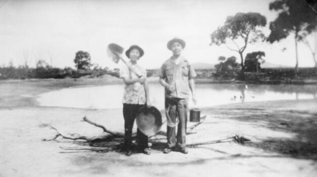 'Miss Ann Mow Fung & her father Mr Fred Mow Fung with shovel gold panning dish and billy -Mr Fred Mow Fung's father had a hotel at Deep Lead'