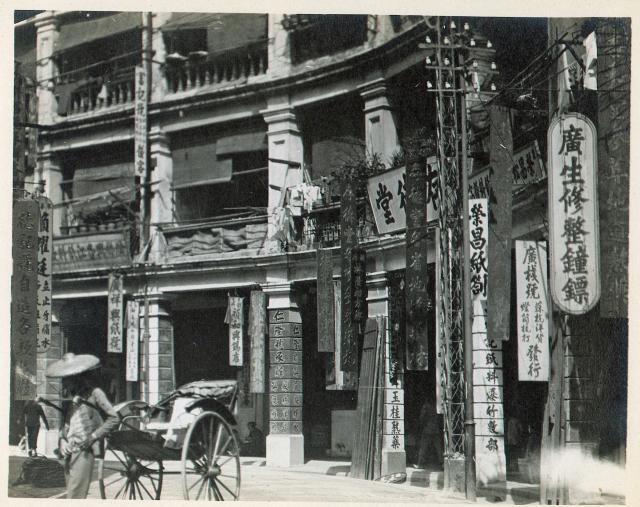 A carriage in front of stores