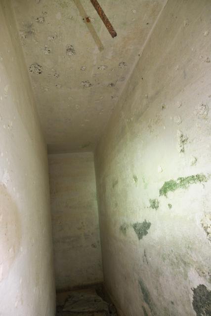 Heavy grenade blast and shrapnel damage inside the doorway, Sai Wan Hill Fort