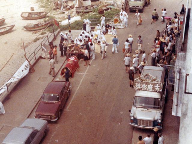 Street funeral, looking down from Sea and Sky court, Stanley Main street, squatter area in back levels-crop