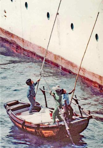 Sampan beggers trying to entice departing cruise ship passengers to throw cashts 1966