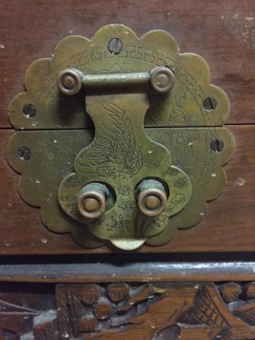 Ornate metal latch on old camphor wood chest