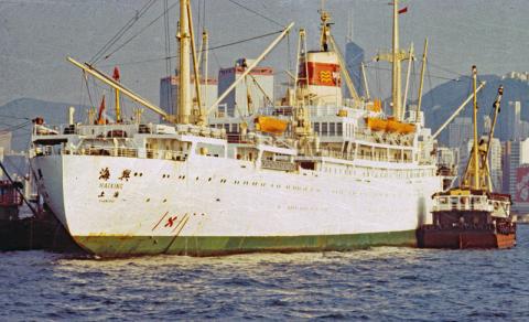 HAIXING passenger freighter with pinched stern loading in mid harbour 