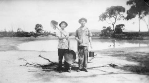 'Miss Ann Mow Fung & her father Mr Fred Mow Fung with shovel gold panning dish and billy -Mr Fred Mow Fung's father had a hotel at Deep Lead'