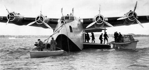 Boeing 314 loading passengers from a launch