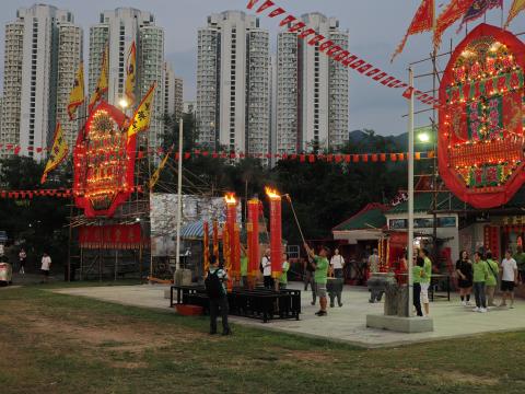Lighting up the biggest incense sticks in front of Hau Wong Temple