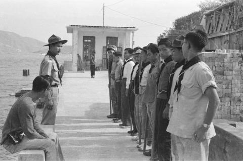 Scouts standing at attention on a pier