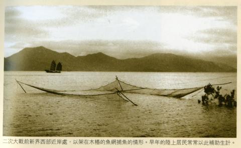 Net fishing lowered into the sea -caption?