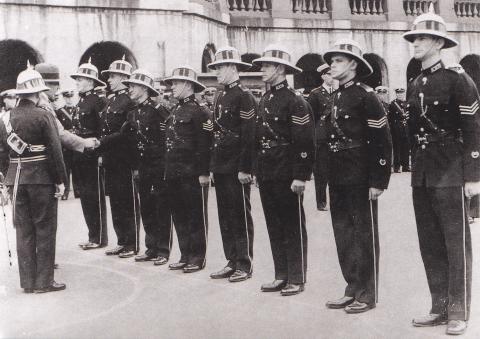 Sir Geoffry Northcote presenting medals to police officers at the Central Police Station 