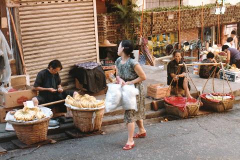 Fruit sellers with poles.