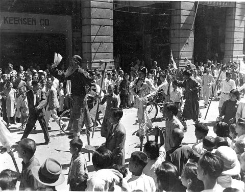 People parading in a street (Oct. 1945)