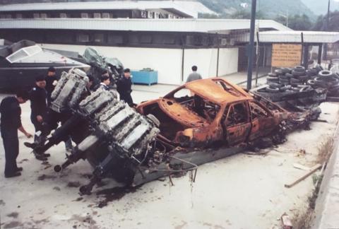 A burnt-out daai fei and vehicle.