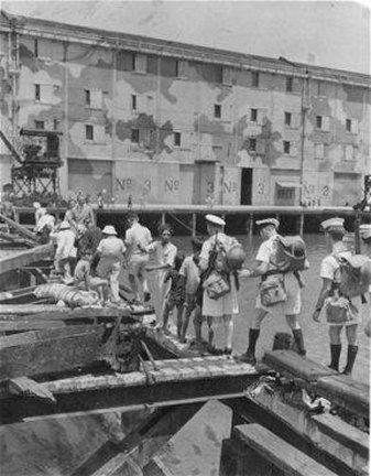 Landing platoon sending Chinese back across a damaged pier/bridge at Kowloon