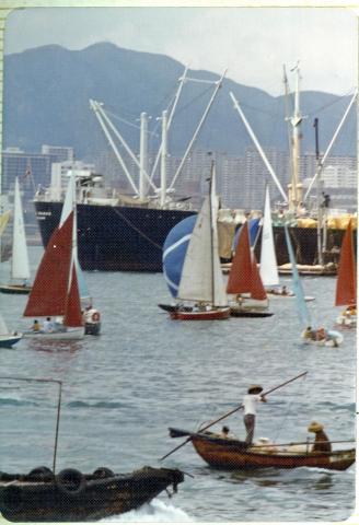 Boats racing in the crowded Hong Kong Harbor
