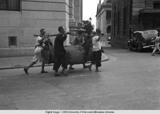 Hong Kong, men carrying a load with a yoke