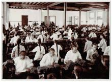 Workers seated at tables