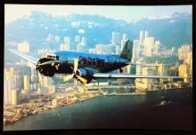 A photo of the old Cathay Pacific Airways DC-3 flying over the Hong Kong Victoria Harbour