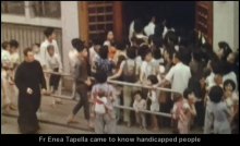 Still of Father Enea Tapella and people in 1964