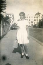 1948 Corrine in KGV School uniform outside her home on Cameron Road, Kowloon