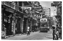 Kowloon domestic washing drying poles hanging over the busy street-1960s