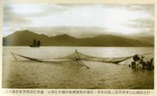 Net fishing lowered into the sea -caption?