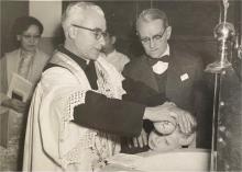 1955 – Father Orlando officiating at the baptismal font, St Theresa’s Church, Kowloon..jpg