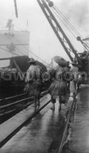 1927 - "Coolies wearing Chinese raincoats"