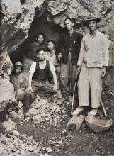 Chinese workers posing at the entrance to their mine