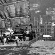 c.1929 Junk in Hong Kong's harbour with Queen's Building in the background