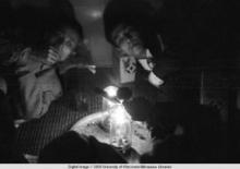 Hong Kong, men smoking in an opium den
