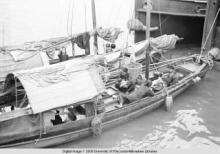 Hong Kong, women and children on boats in a harbor