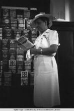 Hong Kong, American evacuee reading United Airlines brochure during World War II
