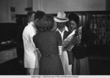 Hong Kong, American evacuees during World War II looking at newspaper